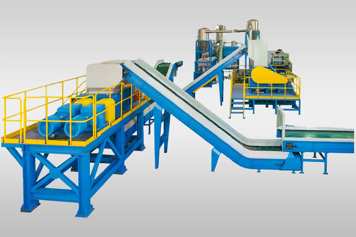 The picture presents a sophisticated industrial setup designed for recycling and processing materials, likely plastics or other similar materials. It showcases a series of interconnected machines and equipment that work together to handle, treat, and transform waste materials into reusable forms. Key Observations: Multiple Stages: The facility is organized into distinct stages, each with specialized equipment, suggesting a multi-step processing approach. Conveyor System: A prominent feature is the conveyor system that transports materials between different processing stages. The main conveyor belt, with a steep incline, carries materials to a higher level, possibly for initial size reduction or sorting. Additional conveyors direct the flow of materials through subsequent stages. Shredder/Granulator (Likely): The machine at the top of the inclined conveyor, with a hopper and yellow safety guards, is likely a shredder or granulator. Its purpose is to break down larger pieces of material into smaller flakes or granules for further processing. Washing and Separation Systems (Likely): The presence of tanks, water lines, and other equipment suggests stages for washing and separating contaminants from the shredded material. This could involve processes like float-sink separation or other washing techniques to remove dirt, labels, or other impurities. Additional Processing Stages (Not Fully Visible): The setup might include further processing steps downstream, such as drying, sorting, or pelletizing, depending on the specific type of material being recycled and the desired end product. Potential Applications and Processes: Plastic Recycling: The facility could be used to recycle various types of plastic waste, such as bottles, films, or rigid plastics. E-Waste Recycling: It might be involved in processing electronic waste to recover valuable metals and other components. Other Material Recycling: The system could be adapted to handle other recyclable materials like paper, cardboard, or textiles, depending on the specific configuration of the equipment. Benefits: Resource Recovery: The facility enables the recovery of valuable resources from waste materials, reducing landfill disposal and promoting sustainability. Waste Reduction: It helps to minimize the volume of waste that needs to be disposed of, contributing to environmental protection. Circular Economy: By transforming waste materials into reusable forms, the facility supports a circular economy and reduces reliance on virgin materials. Economic Advantages: Recycling materials can offer economic benefits by lowering waste disposal costs and creating value from discarded materials. Overall, the picture presents a complex and well-designed industrial system for material recycling and processing. It highlights the importance of recycling in promoting environmental sustainability, resource conservation, and responsible waste management.