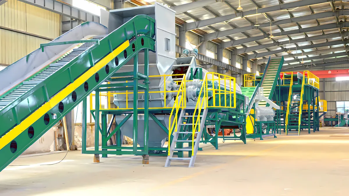 The picture showcases an industrial setup designed for processing and recycling materials, likely solid waste or biomass. It features a series of interconnected machines and equipment that work together to handle, treat, and separate different components of the input material. Key Observations: Conveyor System: A prominent feature is the green conveyor belt that transports material through various stages of the process. There are also additional conveyor belts and chutes for directing the flow of materials. Shredder or Crusher: The large machine with a hopper at the beginning of the line is likely a shredder or crusher. It reduces the size of incoming materials for easier processing. Screening or Separation Equipment: The presence of screens, sieves, or other separation mechanisms suggests that the system is designed to separate different components based on size or other properties. Multiple Stages: The setup is organized into distinct stages, each with specific equipment, indicating a multi-step processing approach. Industrial Setting: The large, open space with a high ceiling and overhead cranes is typical of an industrial facility capable of handling significant volumes of materials. Possible Applications and Processes: Solid Waste Recycling: The facility could be used to process municipal solid waste, separating recyclable materials like metals, plastics, and paper from organic matter or other waste components. Biomass Processing: It might be involved in processing biomass materials such as wood chips, agricultural residues, or energy crops, preparing them for further use as fuel or in other applications. Composting: The system could be part of a composting facility, where organic materials are broken down into compost. Construction & Demolition Waste: Processing construction and demolition waste to recover reusable materials like wood, metal, and concrete. Benefits: Resource Recovery: The facility enables the recovery of valuable resources from waste materials, reducing landfill disposal and promoting sustainability. Waste Reduction: It helps to minimize the volume of waste that needs to be disposed of, contributing to environmental protection. Energy Generation: In some cases, the processed materials could be used for energy generation, such as through biogas production or incineration with energy recovery. Overall, the picture presents a sophisticated industrial system that plays a crucial role in resource recovery, waste management, and sustainable material processing.