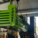 Worker operating industrial machinery installation.