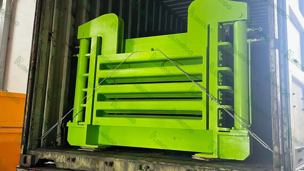 Large green metal equipment secured in a shipping container