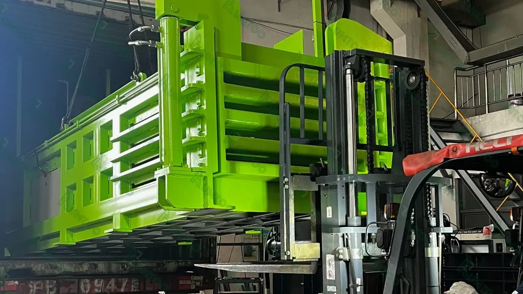 Forklift moving bright green industrial equipment.