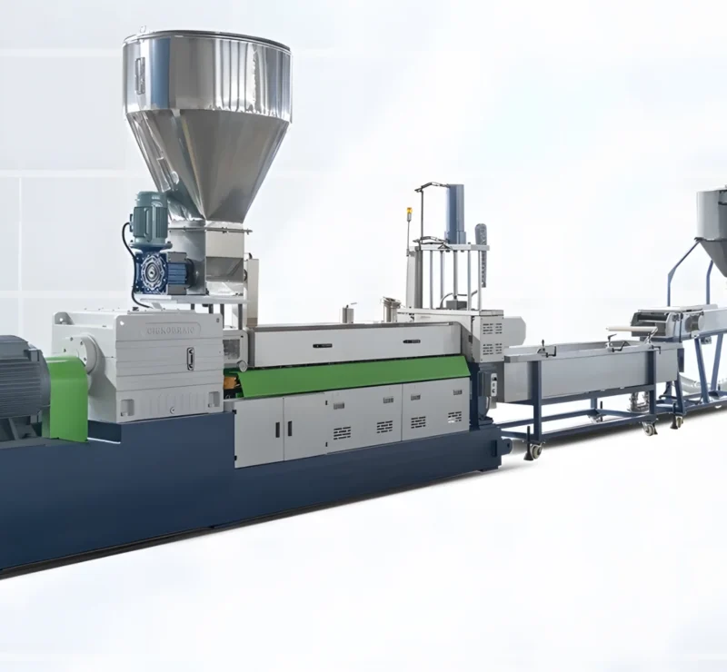 The image shows an industrial plastic extrusion line. This machinery is used for the production of plastic products by melting raw plastic material and forming it into a continuous profile. The equipment includes various components such as a hopper for raw material input, an extruder where the plastic is melted and pushed through a die to shape it, cooling systems, and possibly cutting or rolling mechanisms for the final product handling. The setup is typically used in manufacturing processes for creating plastic pipes, sheets, films, and other profiles.