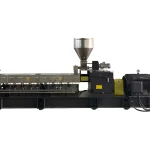 The image shows an industrial machine, which appears to be a plastic granulator or extrusion machine. This equipment is commonly used in the plastic processing industry for recycling or creating plastic pellets. It includes components like a hopper for feeding plastic material, an extrusion chamber, and a motor, which drives the extrusion process. The processed plastic is typically melted, extruded, and formed into pellets or other shapes.