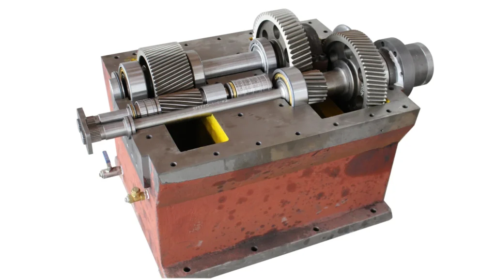A close-up view of a gearbox with its internal components exposed. The image showcases the intricate arrangement of gears, shafts, and bearings inside the metal housing. The gears are made of high-strength steel, indicating durability and precision engineering. This gearbox is designed for industrial applications, providing efficient power transmission and reducing mechanical wear. The sturdy construction and detailed design highlight its reliability and capability to handle heavy-duty tasks.