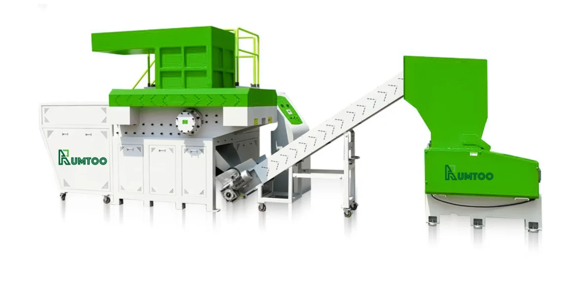 Green and white industrial shredder machine designed for recycling rigid plastic, featuring a conveyor belt and robust cutting mechanism.
